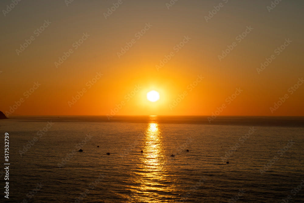 Beautiful sunset over the sea with boat in the middle