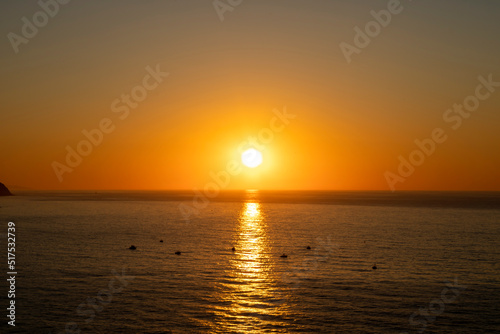 Beautiful sunset over the sea with boat in the middle © JoseFelix