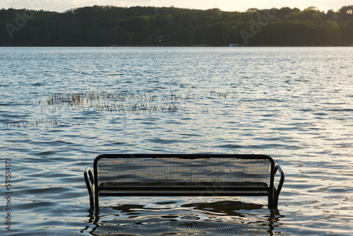 A flooded bench on the edge of a lake in Buckow in Brandenburg