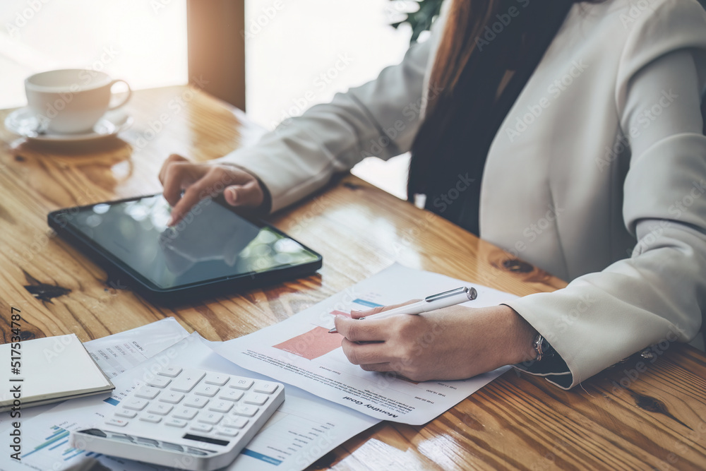business woman using pen pointing budget document with tablet computer for data analysis, marketing, accounting business woman using pen pointing budget document with tablet computer for data analysis, marketing, accounting