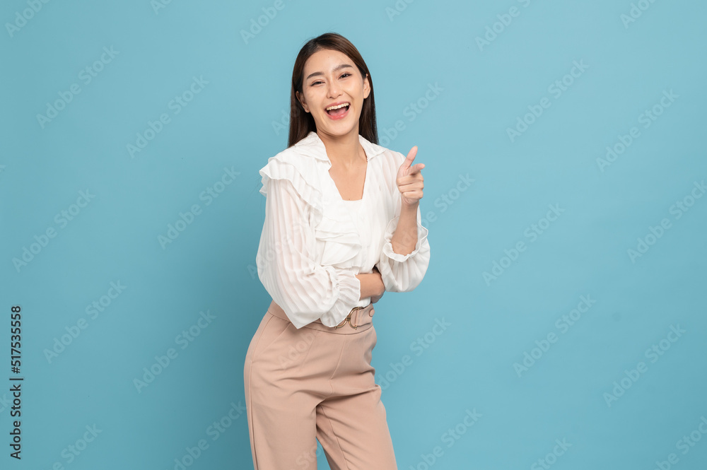 Young beautiful asian woman with smart casual cloth smiling and giving thumbs up isolated on blue background Young beautiful asian woman with smart casual cloth smiling and giving thumbs up isolated on blue background