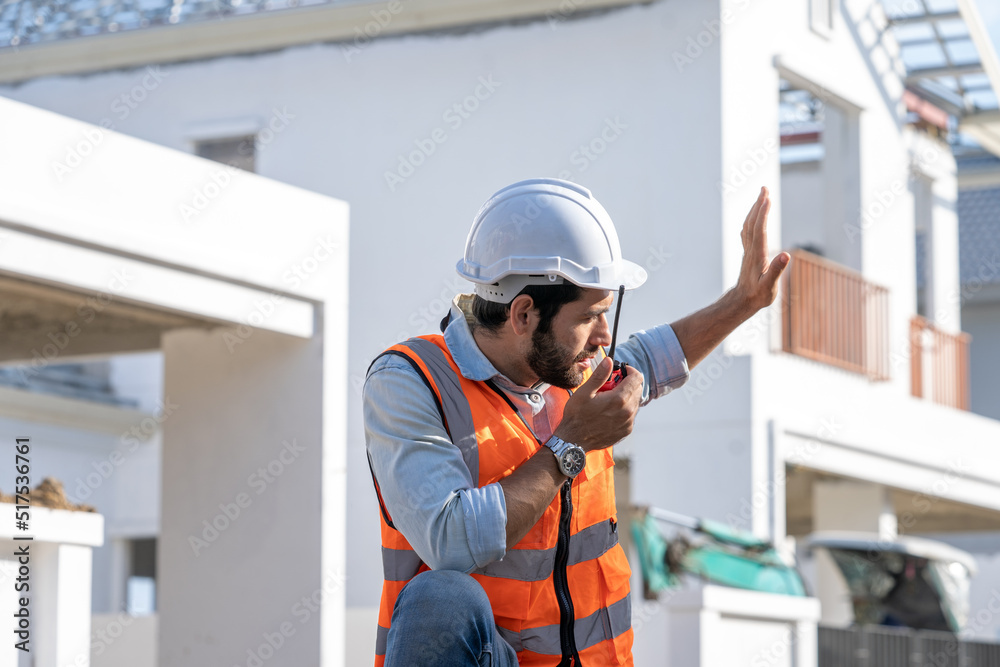 Engineer holding Walkie-Talkie are working at construction site and wearing hardhat. Engineer holding Walkie-Talkie are working at construction site and wearing hardhat.