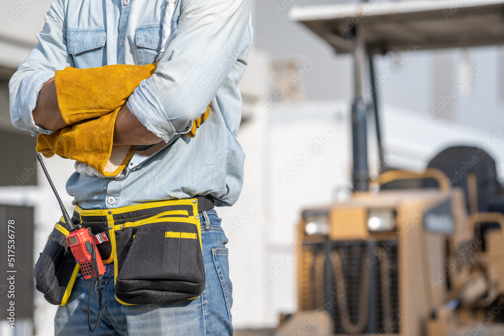 Construction worker wearing safety harness and safety line working at high place at construction site,Engineer,Construction concept. Construction worker wearing safety harness and safety line working at high place at construction site,Engineer,Construction concept.