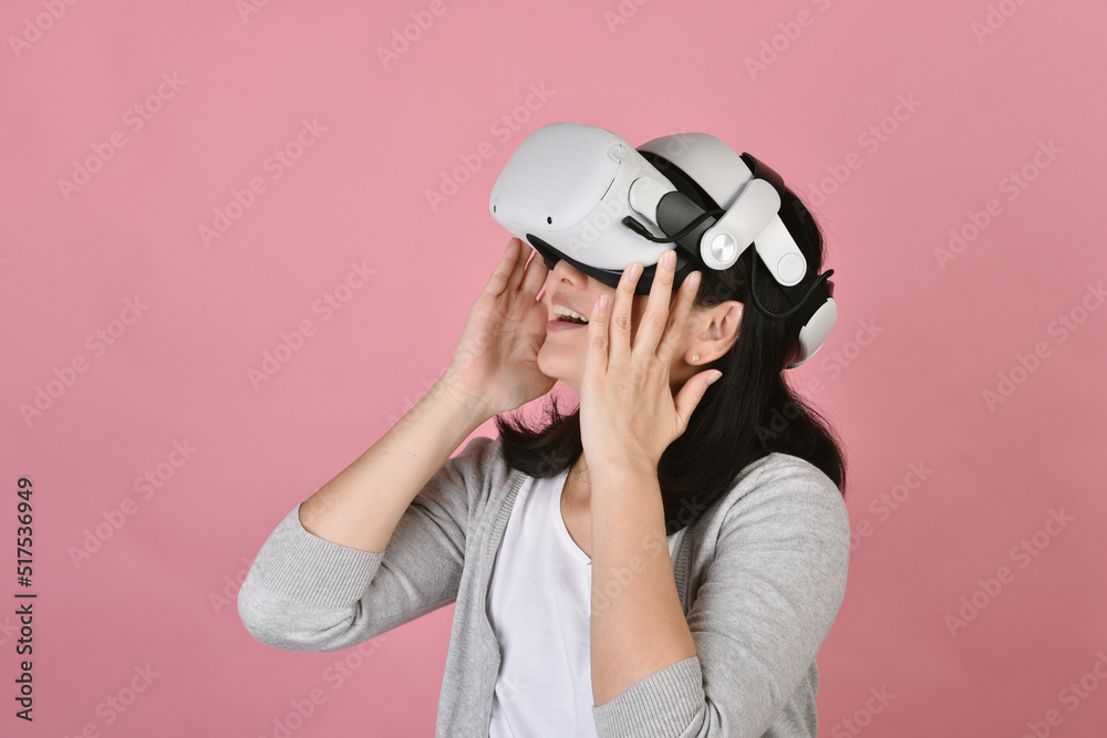 Asian woman using vr glasses, Watching movie and playing video games from virtual reality headset, Young woman amazing with new experience by vr technology, Studio shot.
