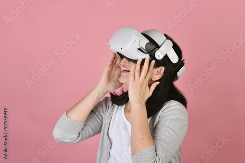 Obraz na płótnie Asian woman using vr glasses, Watching movie and playing video games from virtual reality headset, Young woman amazing with new experience by vr technology, Studio shot. w salonie