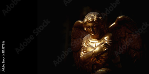 Praying angel with arms across chest. Copy space.