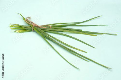 Fresh green onions on bright blue background. Healthy eating concept