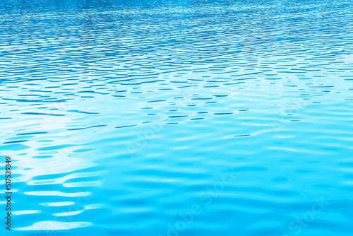 Water in swimming pool rippled water detail background.