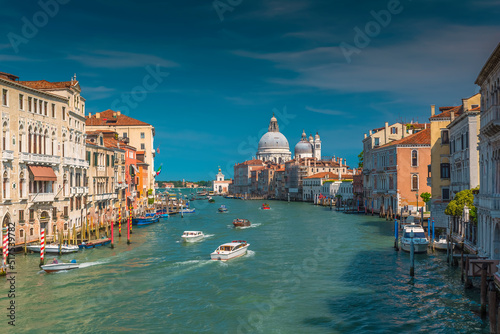 Busy boat traffic on the Grand Canal in Venice with the famous Santa Maria della Salute Basilica in the background