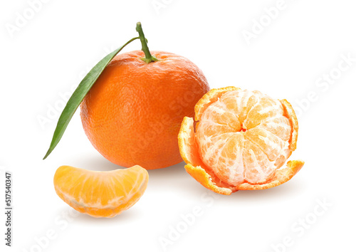 Tasty ripe tangerines and green leaf on white background