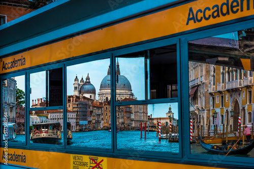 Reflection of the famous Basilica Santa Maria della Salute in a window of a local Vaporetto stop at Accademia bridge  photo