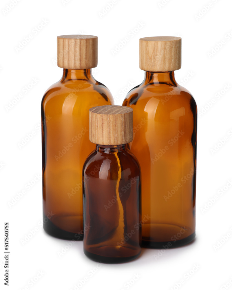New empty glass bottles with wooden caps isolated on white New empty glass bottles with wooden caps isolated on white