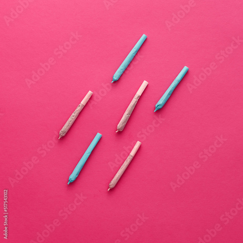 Cannabis rolled joints isolated on pink background