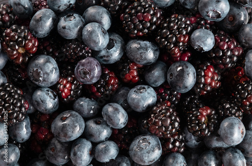 Background of blueberries and blackberries top view. Horizontal orientation  flatlay  no people