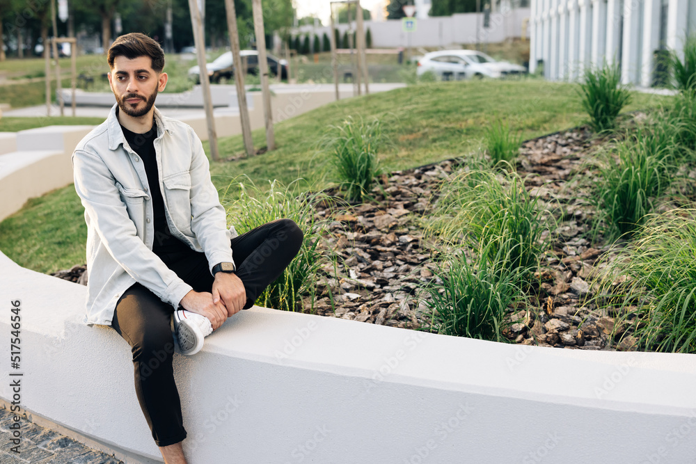 Gorgeous young bearded mixed-race elegant man with brown eyes looking stright outdoors. Outdoor relax. Happy relax. Male portraits. Gorgeous young bearded mixed-race elegant man with brown eyes looking stright outdoors. Outdoor relax. Happy relax. Male portraits.