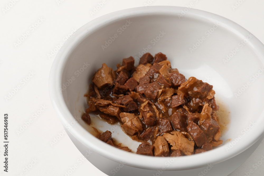 Bowl with wet cat food on white background, closeup Bowl with wet cat food on white background, closeup