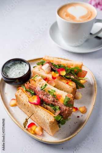 Toast sandwich with cheese and ham filled with tomato and lettuce