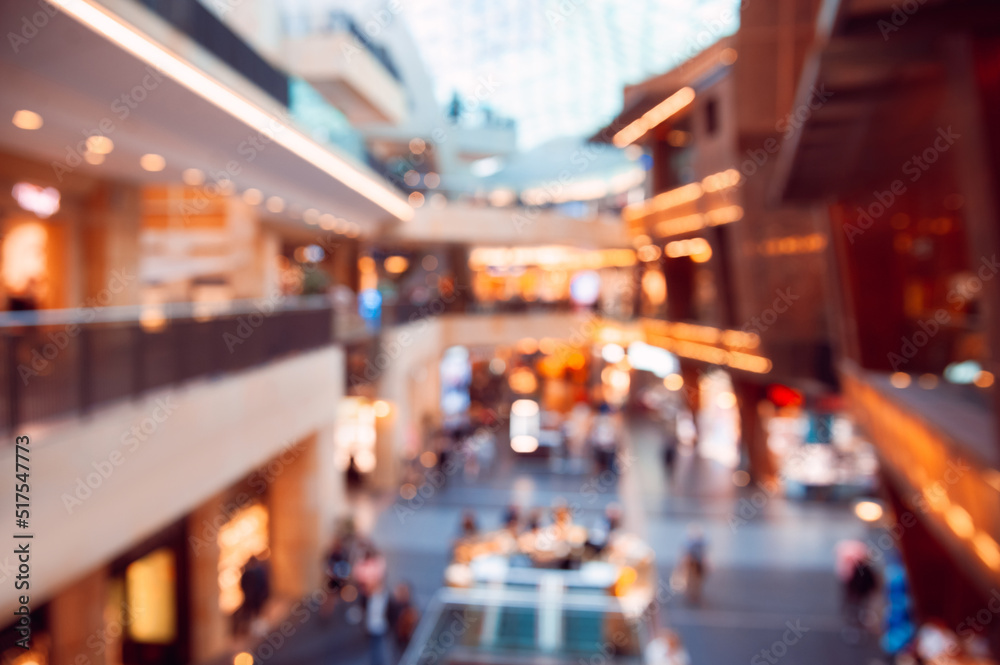 Big shopping mall with many stores, blurred view