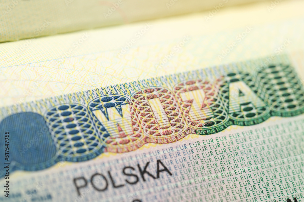Fototapeta premium MYKOLAIV, UKRAINE - FEBRUARY 23, 2022: Passport page with Polish visa, closeup