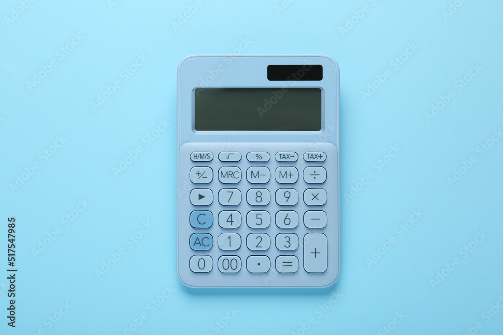 Modern calculator on light blue background, top view Modern calculator on light blue background, top view