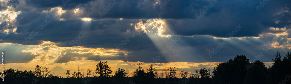 Landscape with the rays of God. Dramatic sky with sun rays shine through the clouds. The power of the sky. Copy space