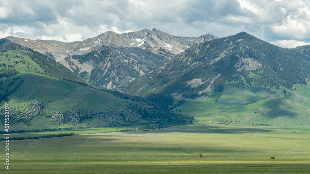 A vast, mountainous landscape under a cloudy sky in western Montana.