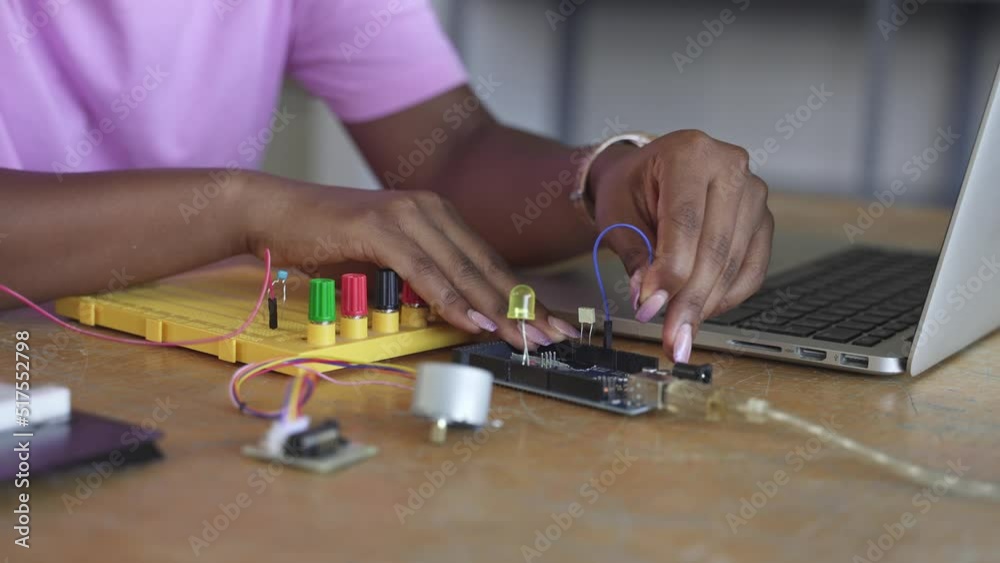 Hands of teenager female Student programming electronics circuit board in the science technology workshop - Learning Digital Innovation at School