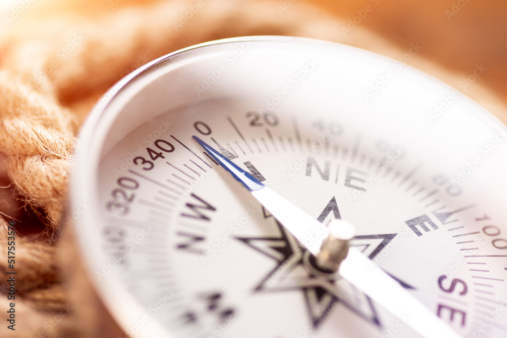 White geographic comp close up. Compass and rope White geographic comp close up. Compass and rope