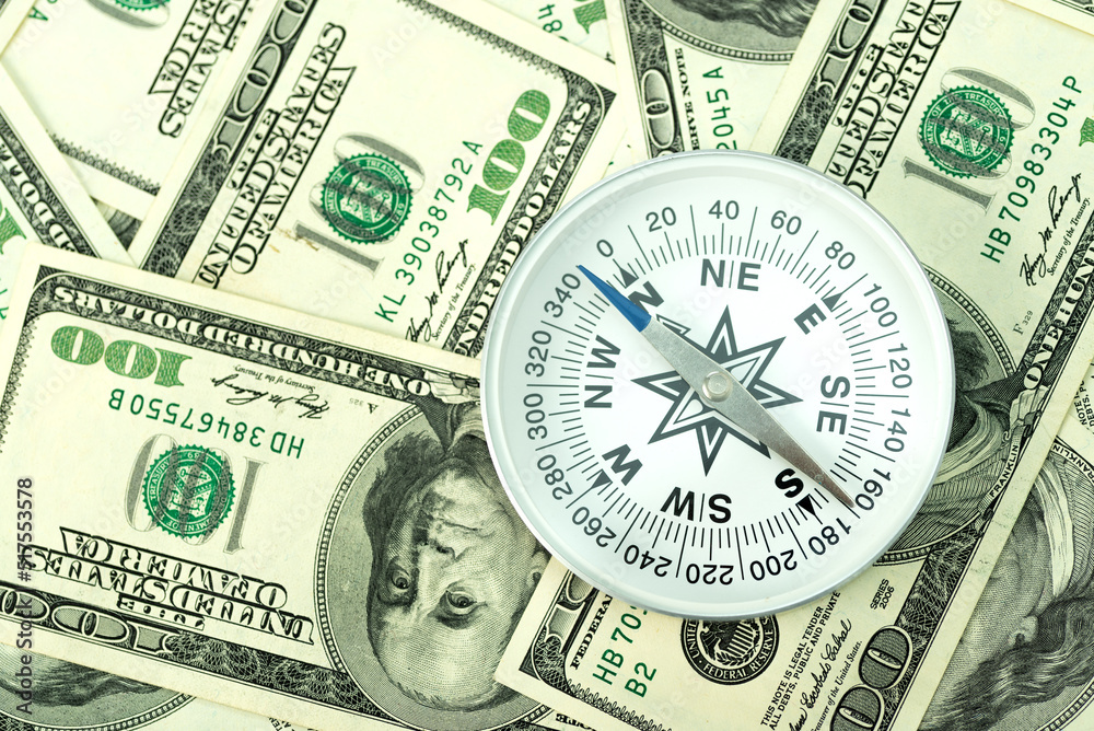 Travel compass on the background of American dollars. Travel concept, travel cost Travel compass on the background of American dollars. Travel concept, travel cost