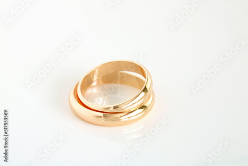 Gold wedding rings on a white.