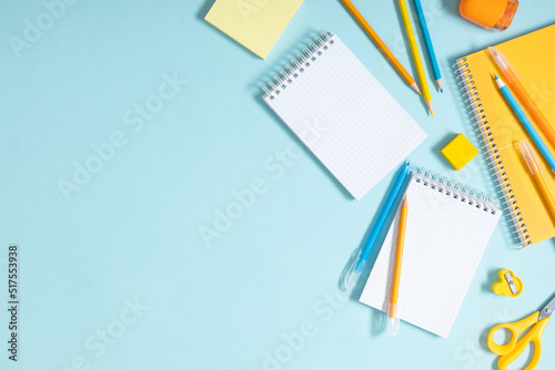 Back to school concept. School accessories on blue background. Flat lay, top view, copy space