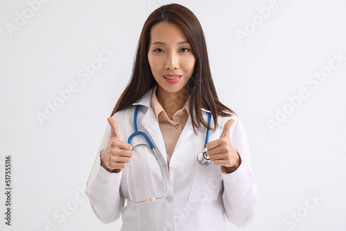 Female Asian doctor showing...