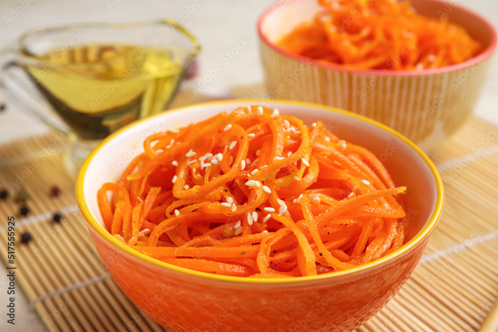 Bowls with tasty korean carrot salad, closeup Bowls with tasty korean carrot salad, closeup