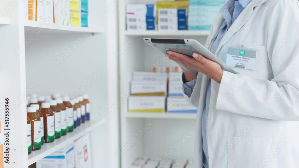 Pharmacist using digital tablet while checking prescription medication at a pharmacy. Medical professional, chemist or pharmaceutical worker doing inventory of medicine stock at a healthcare clinic