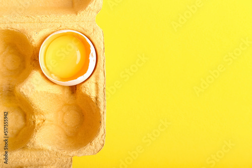 Cracked egg with bright yel...