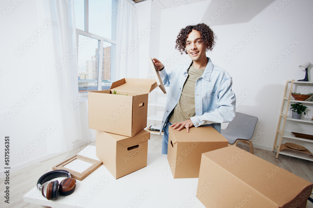 guy with curly hair with boxes moving Lifestyle guy with curly hair with boxes moving Lifestyle