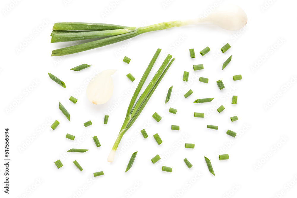 Composition with cut green onion on white background