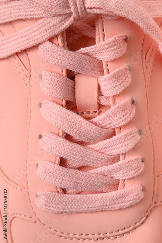 Classic lacing on sports women's pink sneakerslacing on sports women's pink sneakers. Close up.