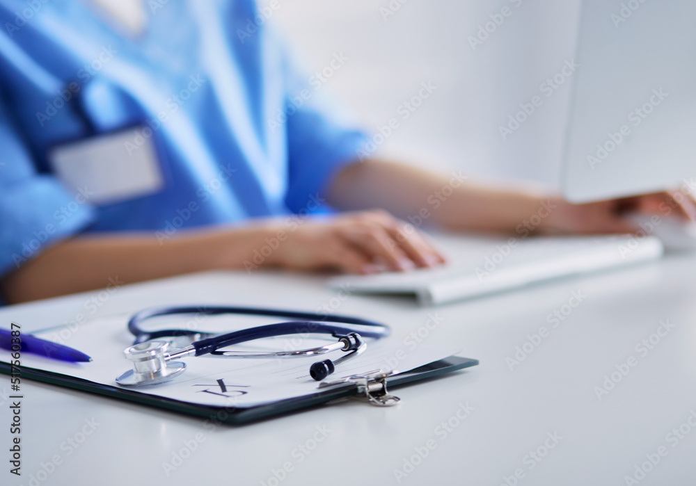 Female doctor sitting and working a laptop