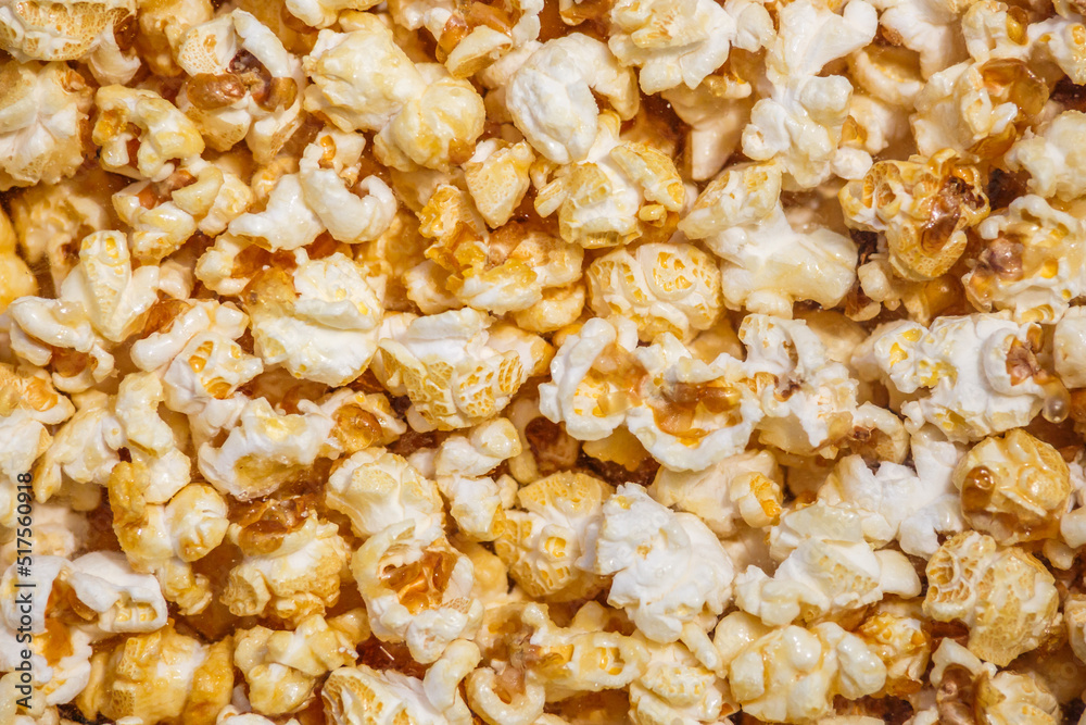 Heap of delicious popcorn, isolated on white background. Scattered popcorn texture background. Top view.popcorn with caramel Heap of delicious popcorn, isolated on white background. Scattered popcorn texture background. Top view.popcorn with caramel