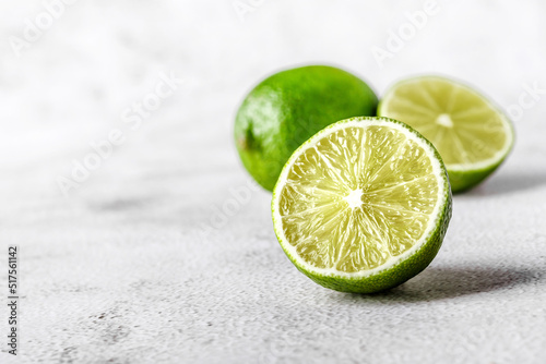 Green lime with cut in half and slices isolated on white background.Healthy green foods - alternative medicine involve a balanced diet with vitamins, nutritions and superfoods for human well-being.