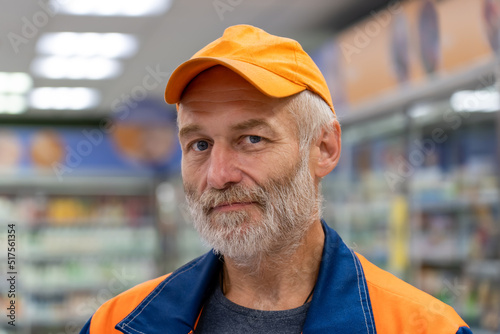 Confident senior handyman looks at the camera in supermarket