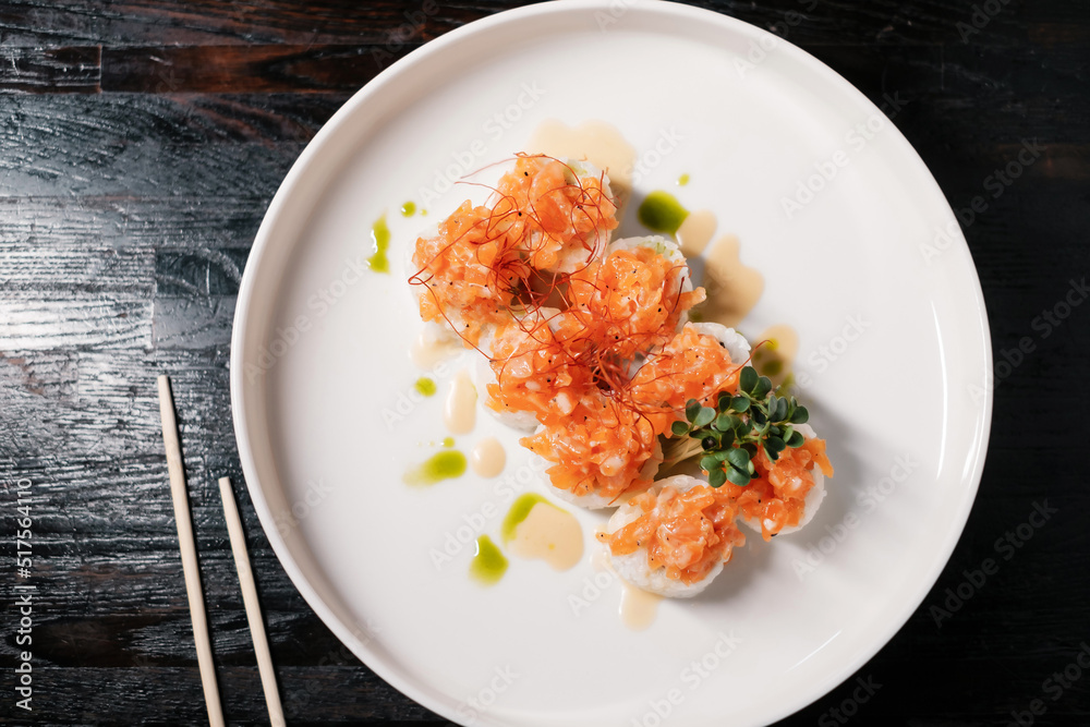 sushi roll set on white plate with chopsticks sushi roll set on white plate with chopsticks