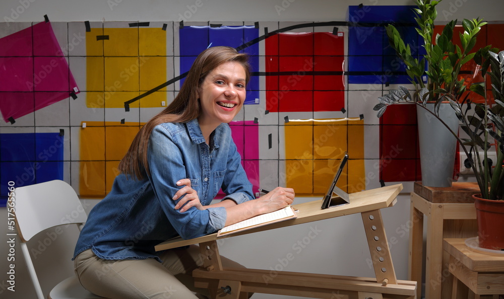 Smiling woman designer or architect professional portrait, working with color palette. Smiling woman designer or architect professional portrait, working with color palette.
