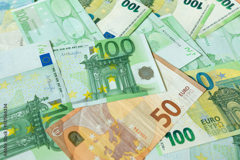 Money background. Euro banknotes in denominations of 50 and 100. The currency of the European Union Money background. Euro banknotes in denominations of 50 and 100. The currency of the European Union