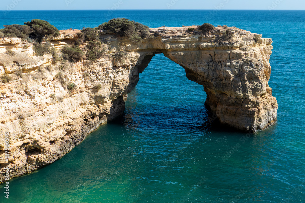Natural Arch of Albandeira during low tide. Landmark in Lagoa, Algarve.