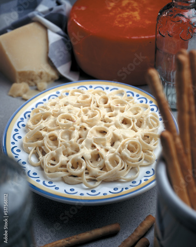 fettuccine Alfredo with cheese in back ground, Italy food