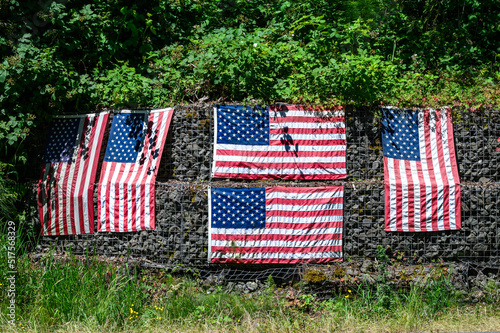 Patriotic roadside display of American flags on a sunny summer day 