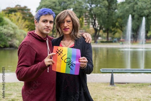 Love. Cheerful queer couple holding a message supporting the LGBT community photo