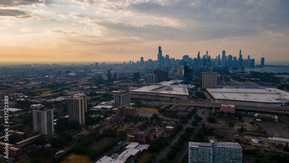 Fototapeta premium establishing aerial drone footage of a Chicago neighborhood downtown. the city beautiful architectural is also covered by lush green trees throughout creating a welcoming view for tourist